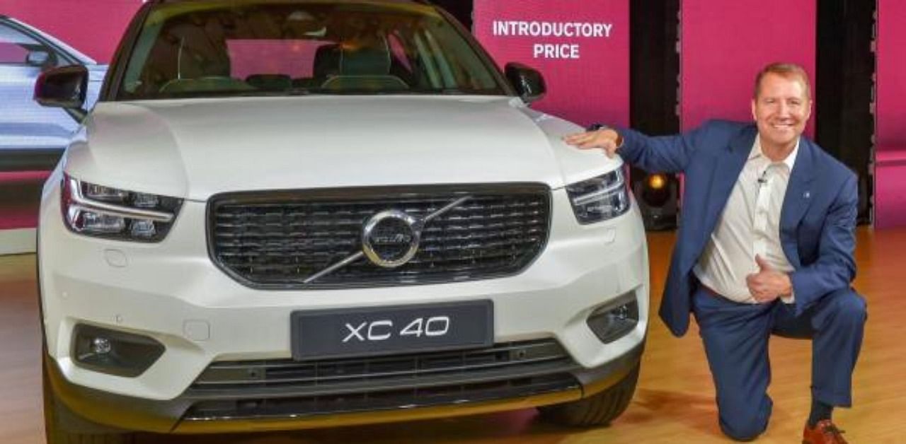 Volvo Car India Managing Director Charles Frump pose with an SUV XC40. Credit: PTI Photo
