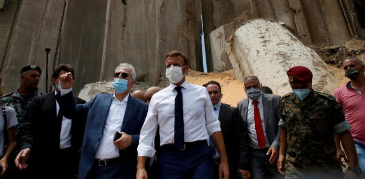 French President Emmanuel Macron gestures as he visits the devastated site of the explosion at the port of Beirut, Lebanon. Credit: Reuters Photo