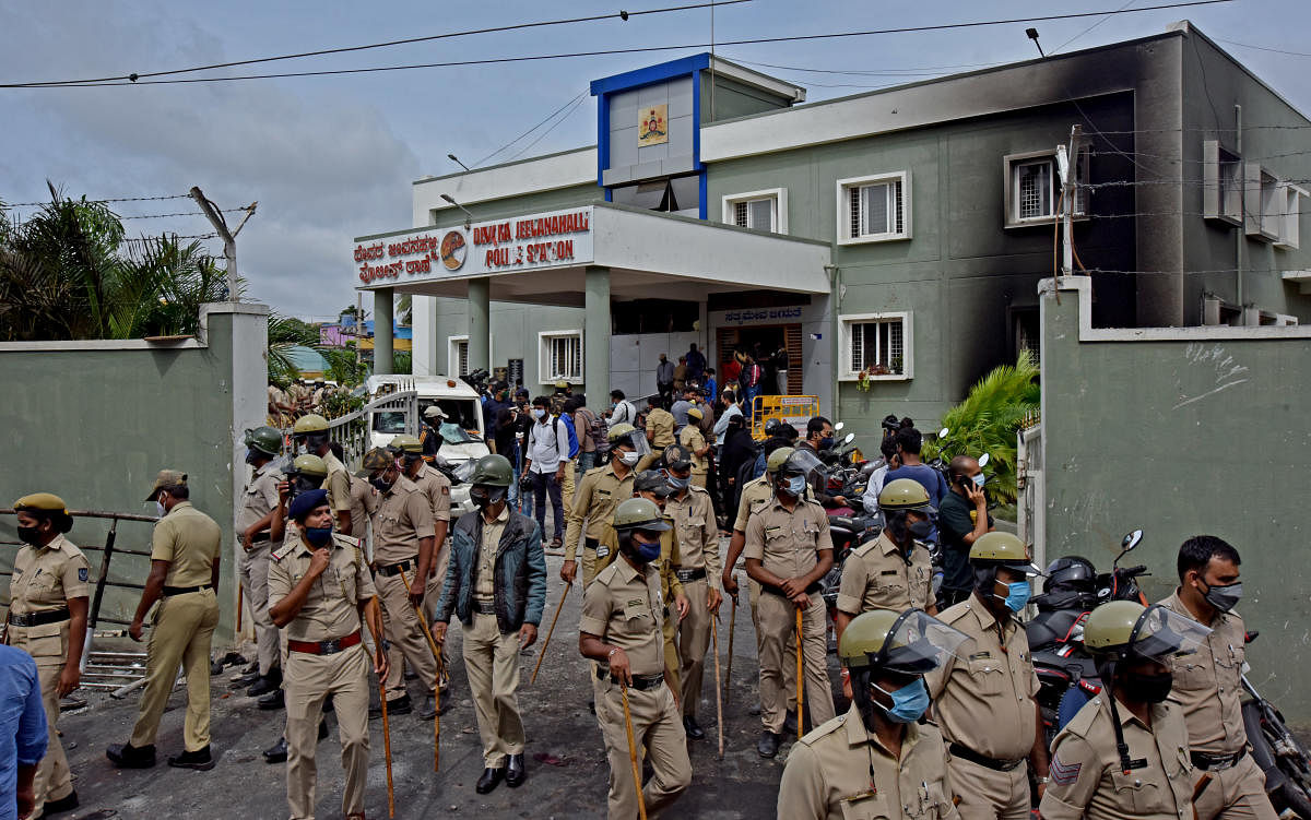 Police cane citizens who were going around at DJ Halli despite ban orders. DH photo