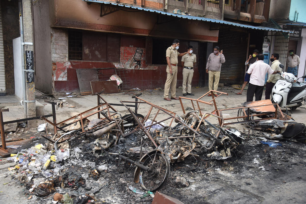 Vehicles burnt by the violent mob on Tuesday incident at Kaval Byrasandra in Bengaluru on Wednesday, August 12, 2020. Credit: DH Photo/S K Dinesh