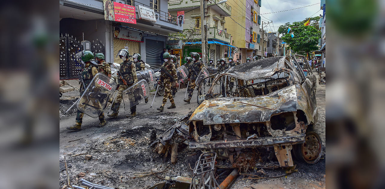 Security personnel carry out a flag march in the riot-hit area after a mob went on a rampage on Tuesday over a social media post, allegedly posted by a Congress MLA's relative, in Bengaluru, Thursday, Aug. 13, 2020. Credit: PTI Photo