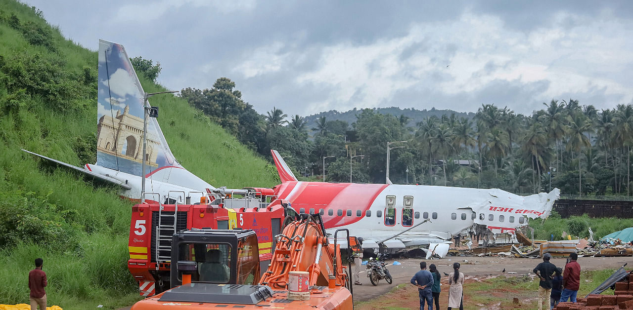 Mangled remains of an Air India Express flight, en route from Dubai, after it skidded off the runway while landing. Credit: PTI Photo