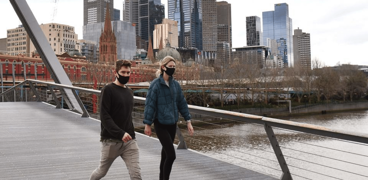 A couple walks on a footbridge over the Yarra River in the Southbank district of Melbourne. Credit: AFP Photo