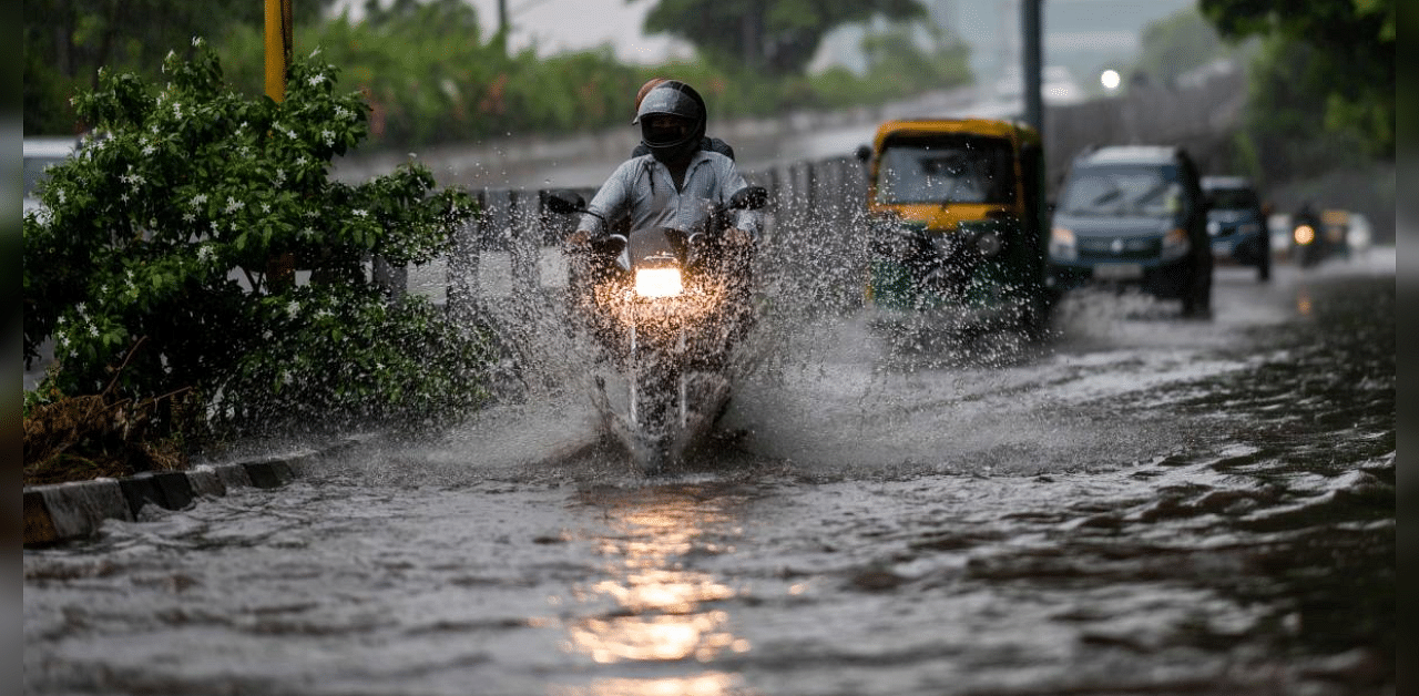 Motorists make their way through a waterlogged street during monsoon rains in New Delhi. Credit: PTI Photo
