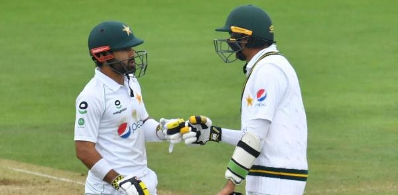 Pakistan's Mohammad Rizwan (L) and Pakistan's Mohammad Abbas (R) talk between overs on the second day of the second Test cricket match between England and Pakistan at the Ageas Bowl in Southampton. Credit: AFP