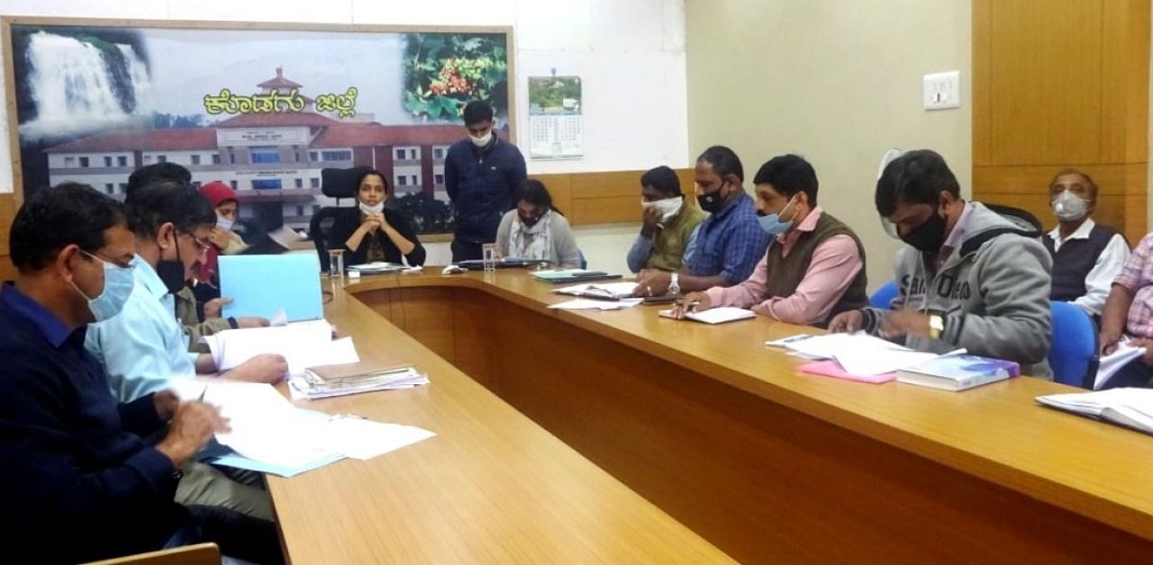 Deputy Commissioner Annies Kanmani Joy chairs a meeting in Madikeri on Friday.