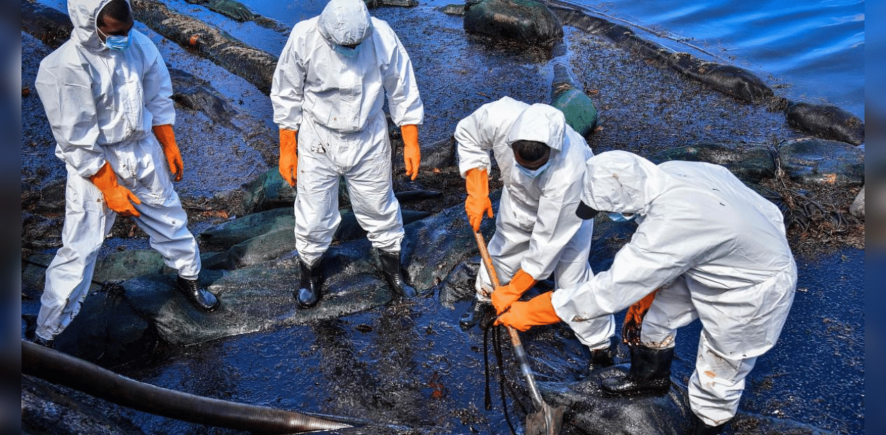 Volunteers collect leaked oil from the MV Wakashio bulk carrier that had run aground at the beach in Bois des Amourettes, Mauritius. Credit: AFP Photo