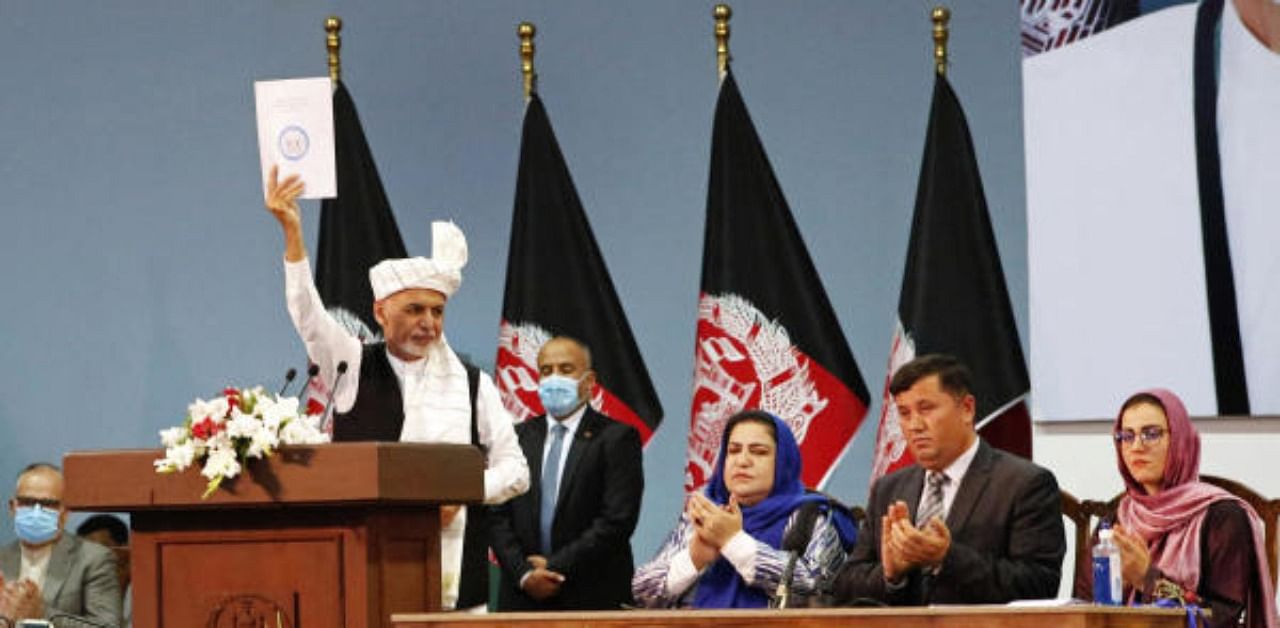 Afghan President Ashraf Ghani holds up the resolution on the last day of an Afghan Loya Jirga or traditional council, in Kabul, Afghanistan. Credit: AP Photo