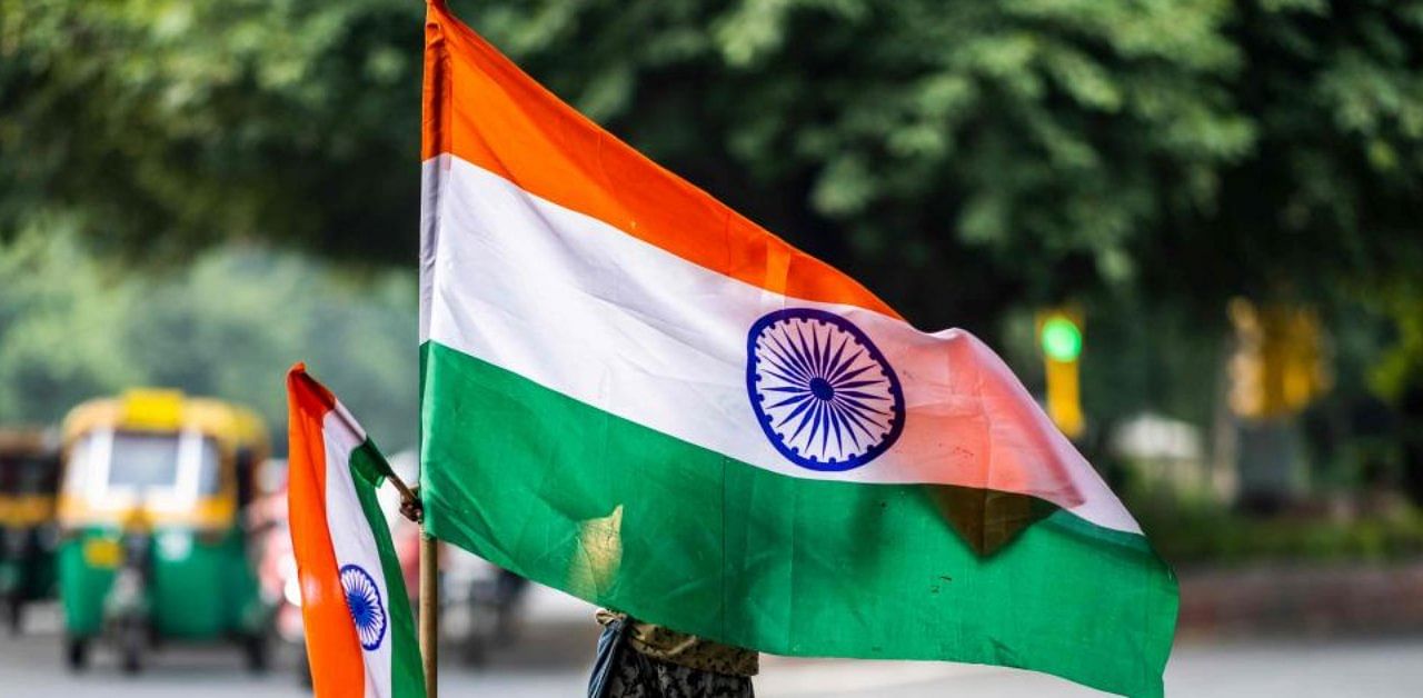 A boy selling Indian national flags looks for customers along a street ahead of the country's 74th Independence Day, which marks the end of British colonial rule, in New Delhi on August 10, 2020. Credit: AFP Photo