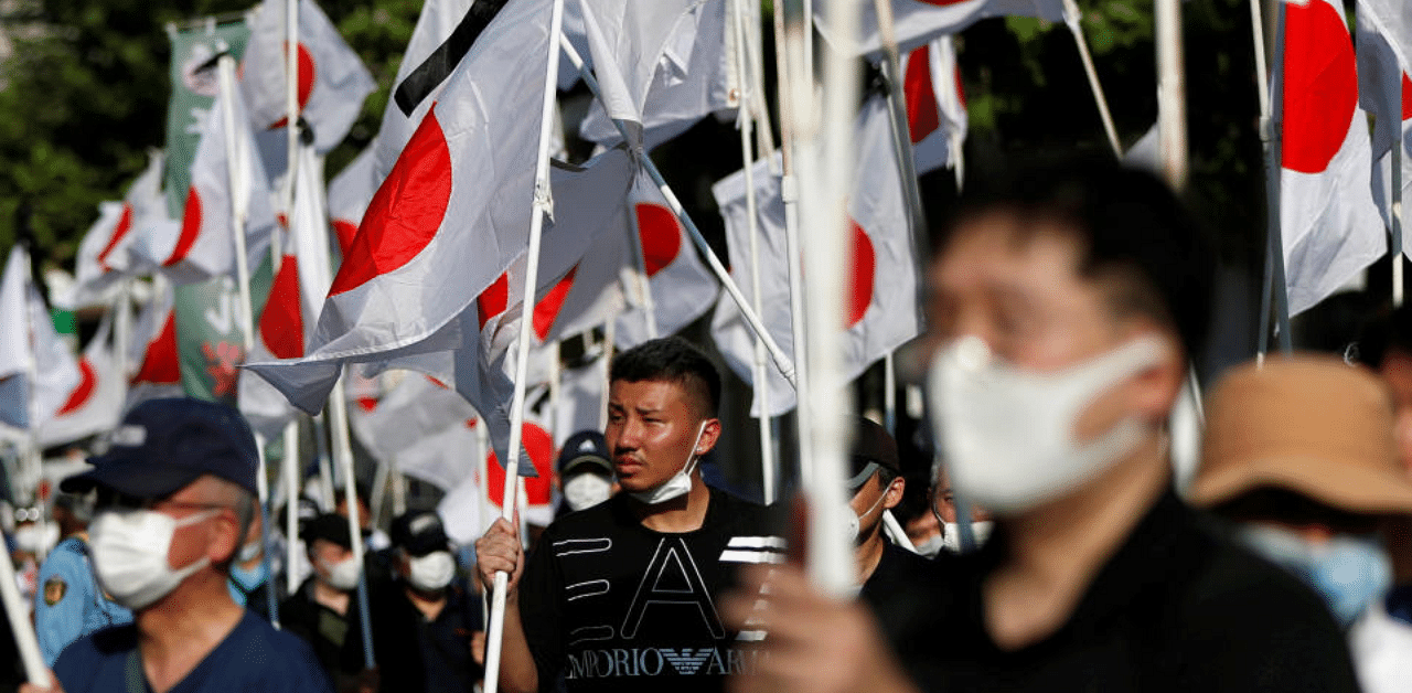 Members of nationalist movement march near the Yasukuni shrine as they pay tribute to the war dead on the 75th anniversary of Japan's surrender in World War II, amid Covid-19, in Tokyo. Credit: Reuters Photo