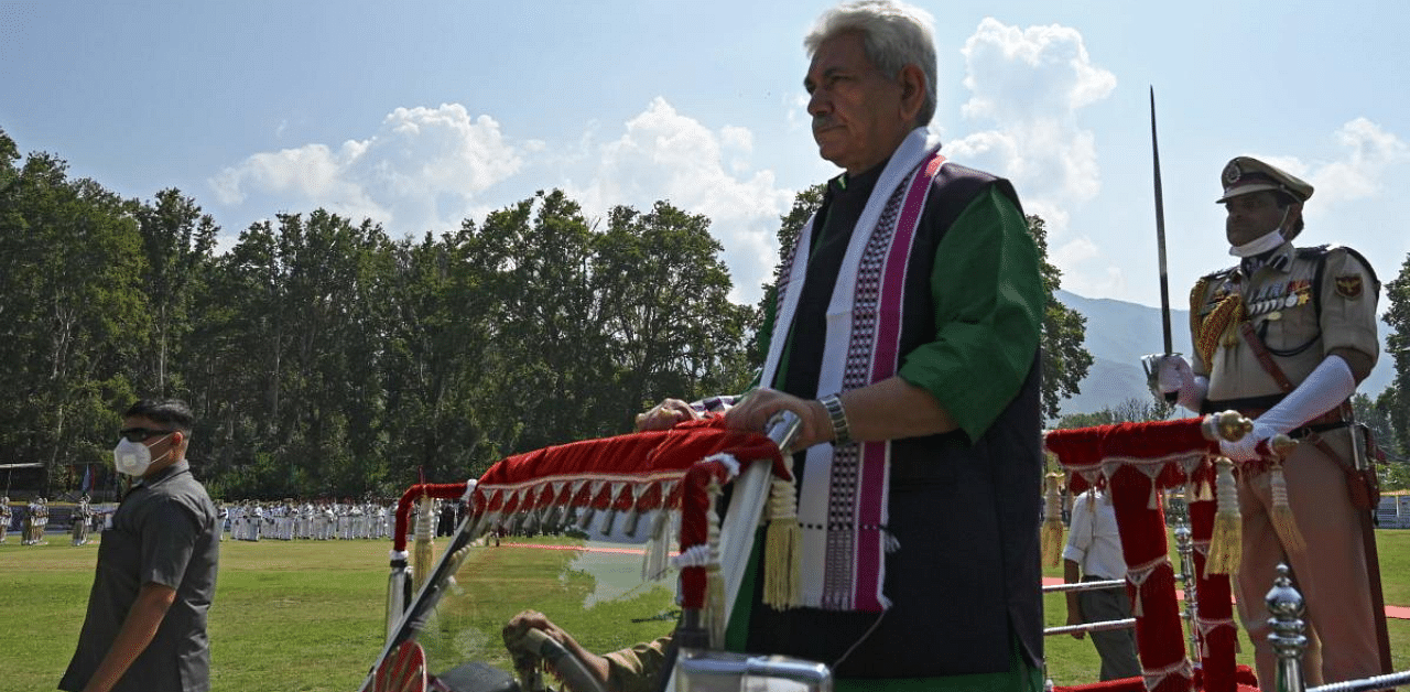 Lieutenant Governor of the Union Territory of Jammu and Kashmir, reviews a guard of a honour during a ceremony to celebrate India's 74th Independence Day. Credit: AFP Photo