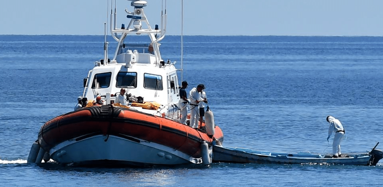 Italy's Guardia Costiera (Coast Guard) boat with migrants enter in the harbour of the Italian Pelagie Island of Lampedusa. Credit: AFP