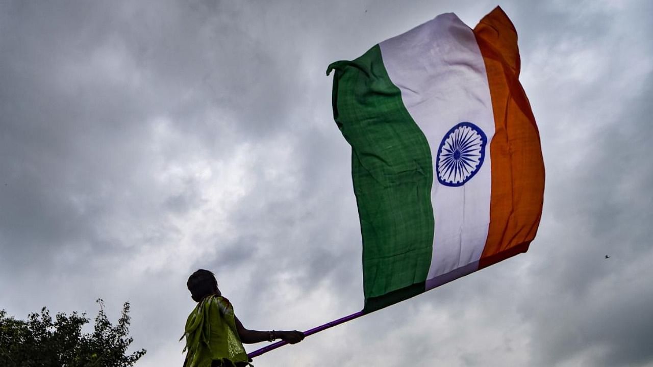 A vendor sells Tricolour flags on the eve of Independence Day. Credit: AFP