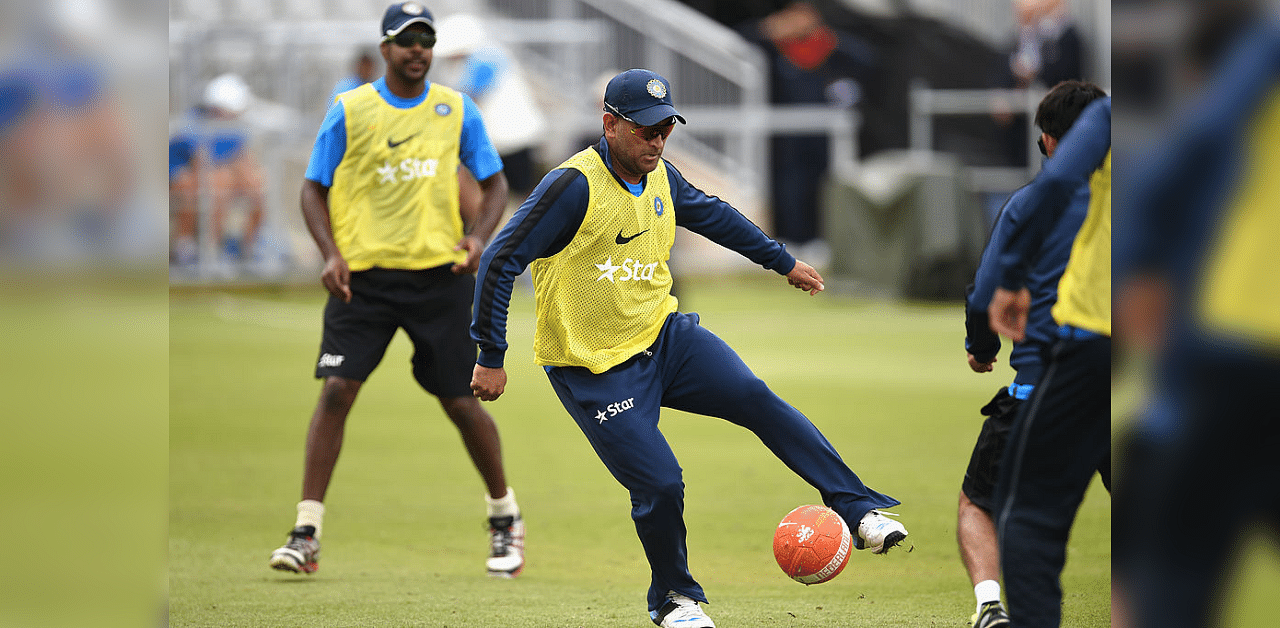 India captain Mahendra Dhoni (c) in action during a game of football during India nets nets ahead of the 4th Test match between England and India, at Old Trafford on August 6, 2014 in Manchester, England. Credit: Getty Images