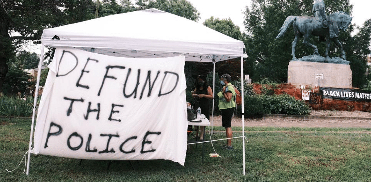 A banner that reads "Defund The Police" is seen during the "Reclaim the Park" gathering at Emancipation Park. Credit: AFP Photo