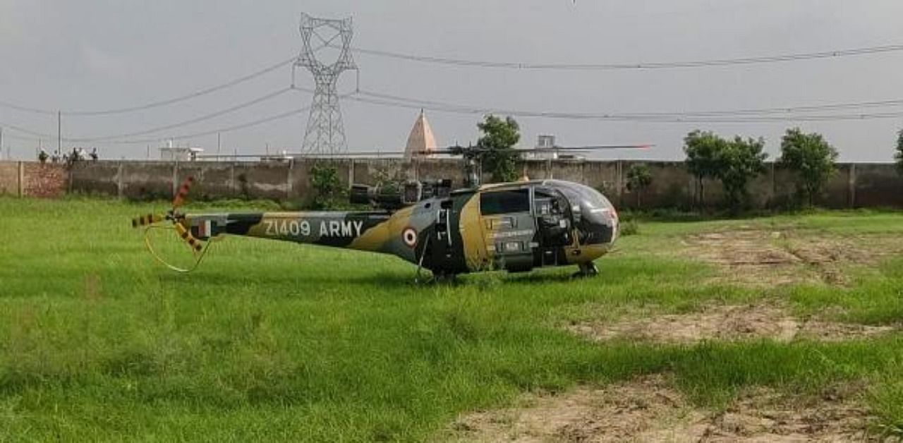 An Indian Army Chetak helicopter makes a precautionary landing near a school, in Mathura. Credit: PTI Photo
