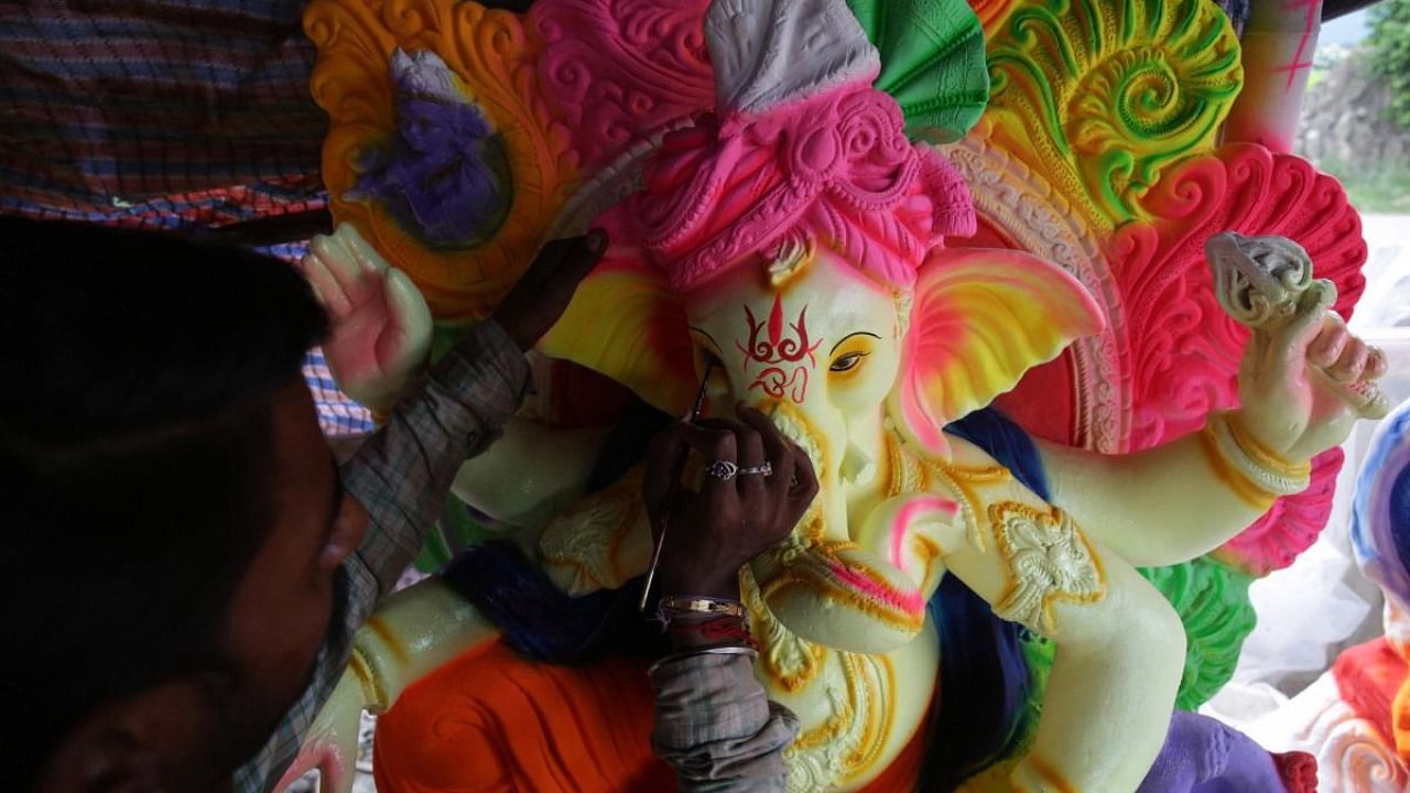 An artisan paints an idol of Lord Ganesh at a workshop for the upcoming Ganesh Chaturthi. Representative image. Credit: PTI