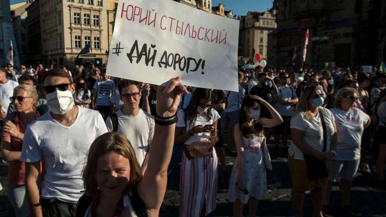 A woman holds a placard with the name of a dead Belarusian demonstrator as she attends a demostration in support of protests against the results of the Belarusian presidential election. Credit: AFP