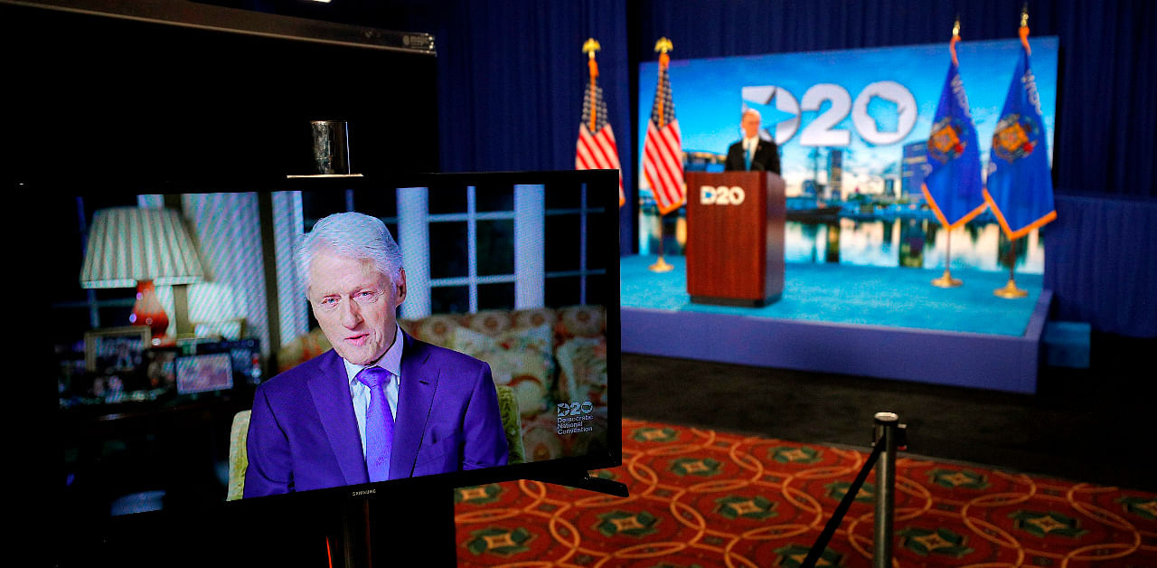 Former President Bill Clinton delivers a speech by video feed as Democratic National Committee Chairman Tom Perez watches from the podium during the second day of the Democratic National Convention, being held virtually amid the novel coronavirus pandemic, at its hosting site in Milwaukee. Credit: AFP Photo