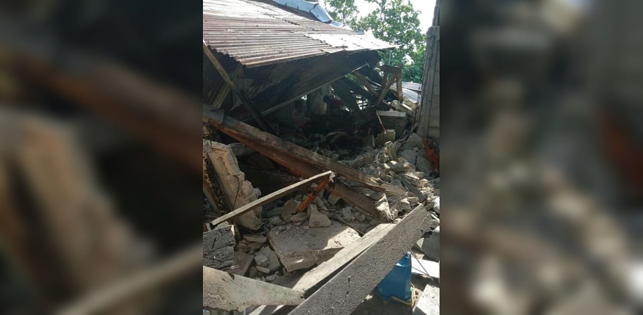 People are seen in a damaged building surrounded by debris in Masbate Province, after an earthquake struck the Philippines. Credit: Reuters