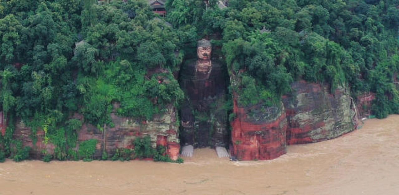 Floodwater reaches the Leshan Giant Buddha's feet following heavy rainfall, in Leshan, Sichuan province, China. Credit: Reuters