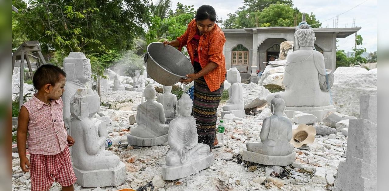 Faces covered in white dust and chisels in hand, marble sculptors in Myanmar say the hills that have given them a livelihood for generations are disappearing, as large companies reap the rewards of the prized white rock. Credit: AFP Photo