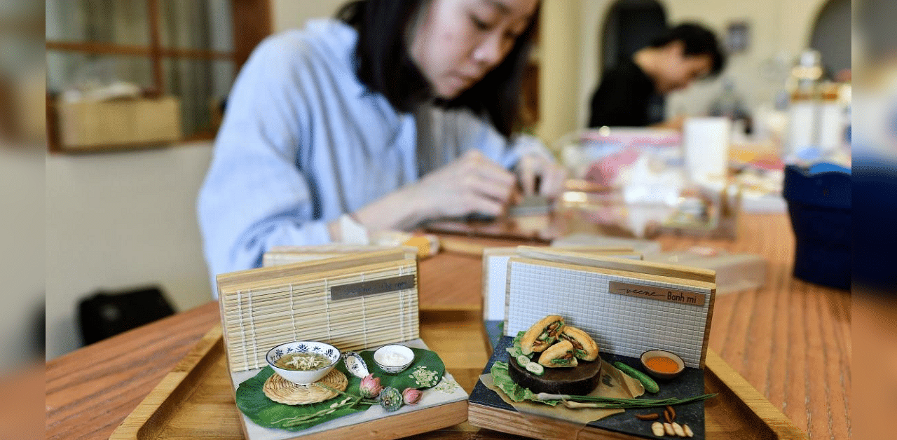 Nguyen Thi Ha An working at her studio in Hanoi. An -- a 28-year-old architecture graduate -- began crafting food miniatures made from clay a year ago, spotting a chance to capitalise on the world's growing love for Vietnamese cuisine. Credit: AFP Photo