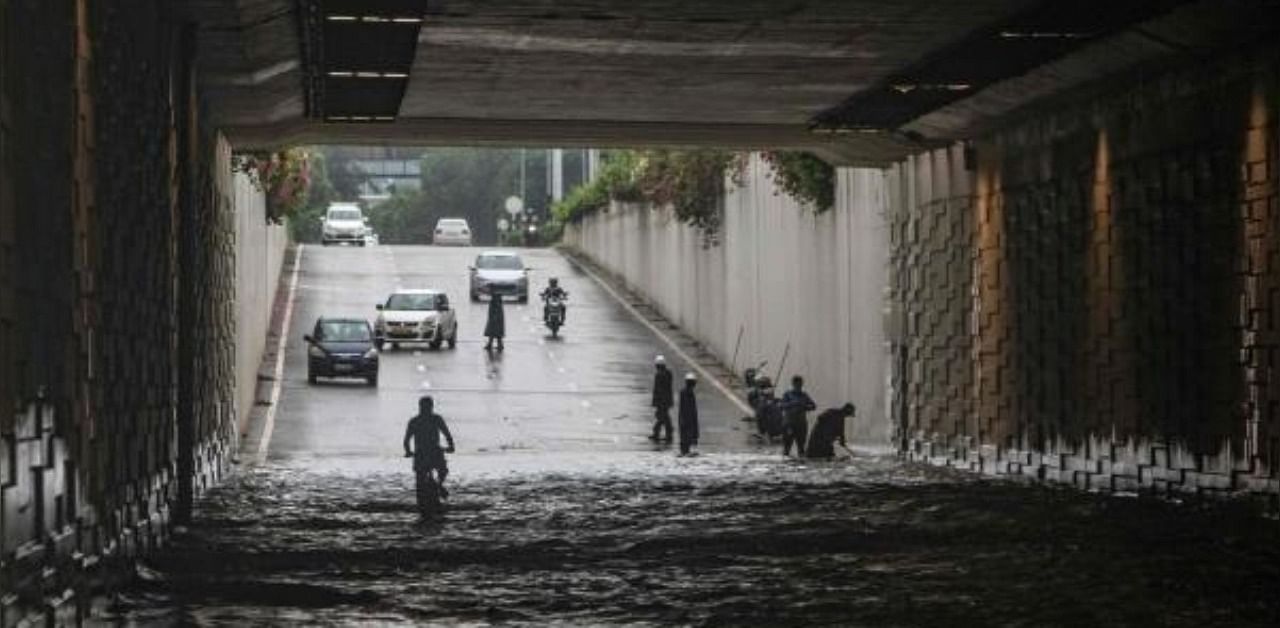 A cyclist rides through a waterlogged road underpass following monsoon rainfalls in Gurgaon on the outskirts of New Delhi. Credit: AFP