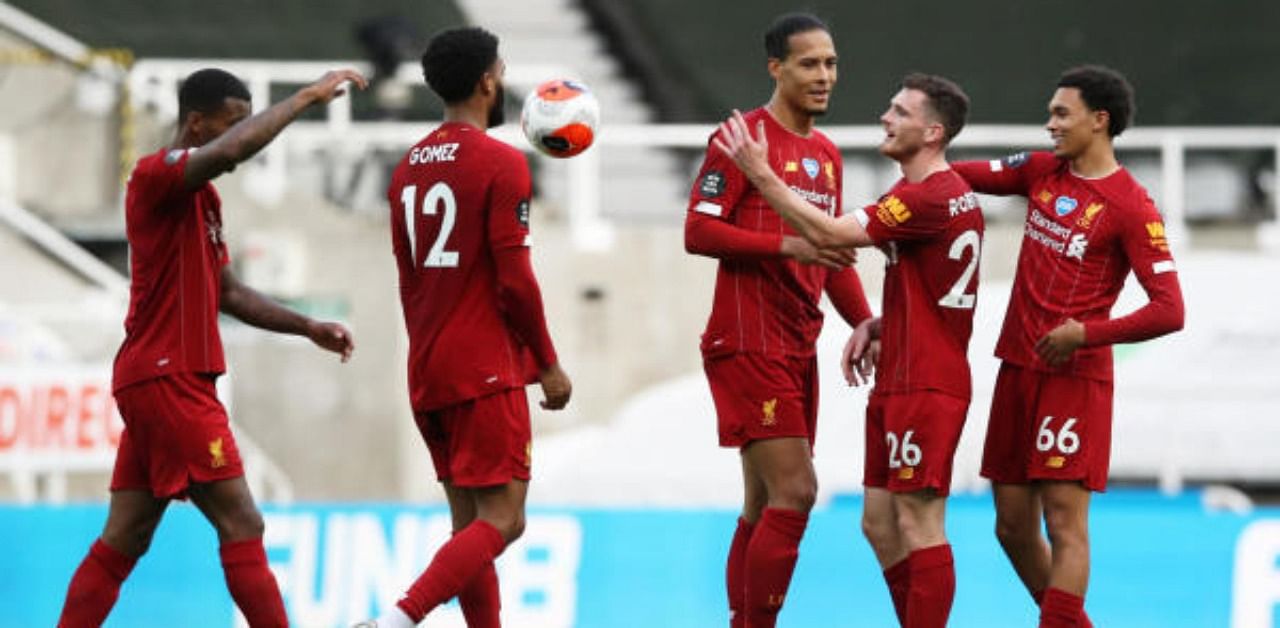 Liverpool's Virgil van Dijk, Andrew Robertson and Trent Alexander-Arnold celebrate after the match. Credit: Reuters