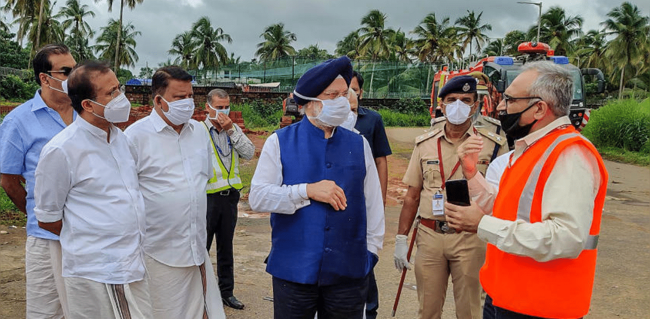 Union Civil Aviation Minister Hardeep Singh Puri enquires during his visit to the crash site of an Air India Express flight. Credit: Twitter Photo (@HardeepSPuri)