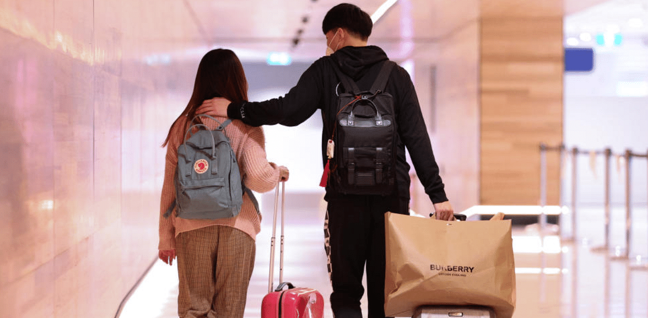 International students, Maggie Zhang and her boyfriend Sunny Gu, leave for catching a flight to China due to the Covid-19 outbreak. Credit: Reuters Photo