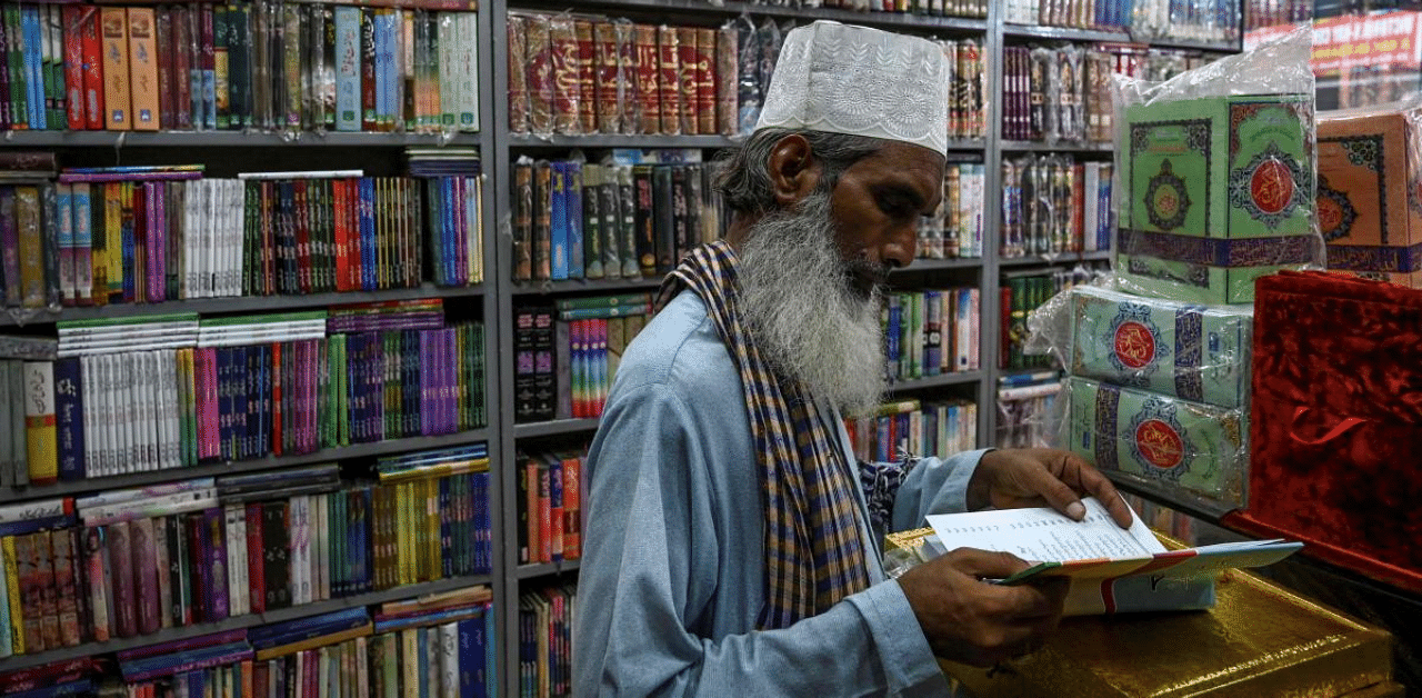 A customer checks a religious book at a store in Lahore. Credit: AFP Photo