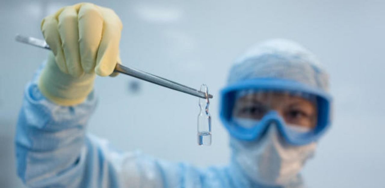 A photo shows an employee demonstrating vials with vaccine against the coronavirus disease. Credit: Reuters