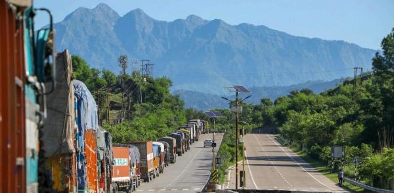Stranded trucks wait for the opening of the Jammu-Srinagar national highway, on the outskirts of Jammu. Credit: PTI
