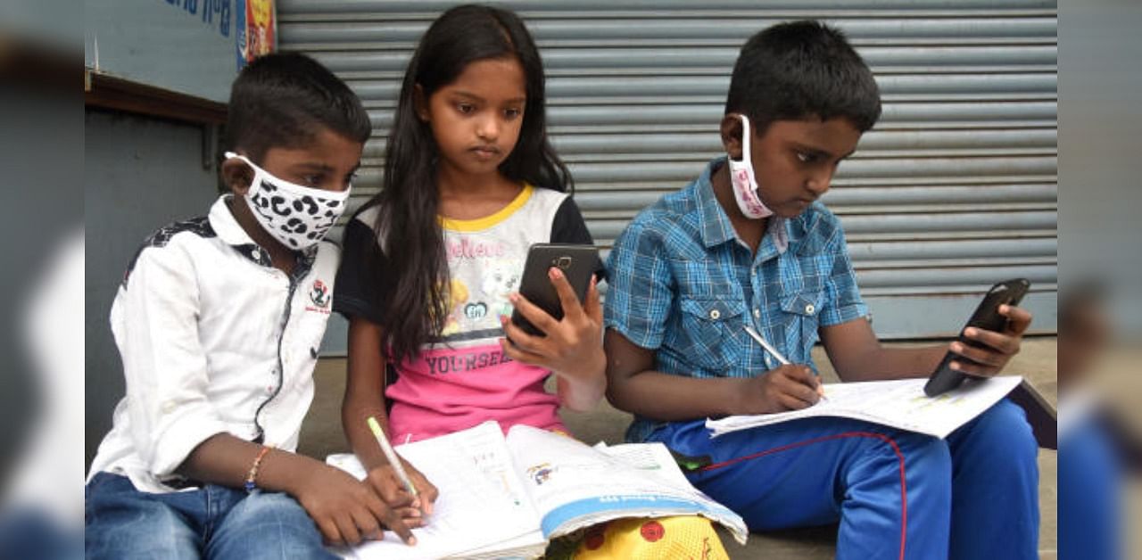 Children learning lesson from online classes through mobile. Representative Image. Credit: DH File Photo