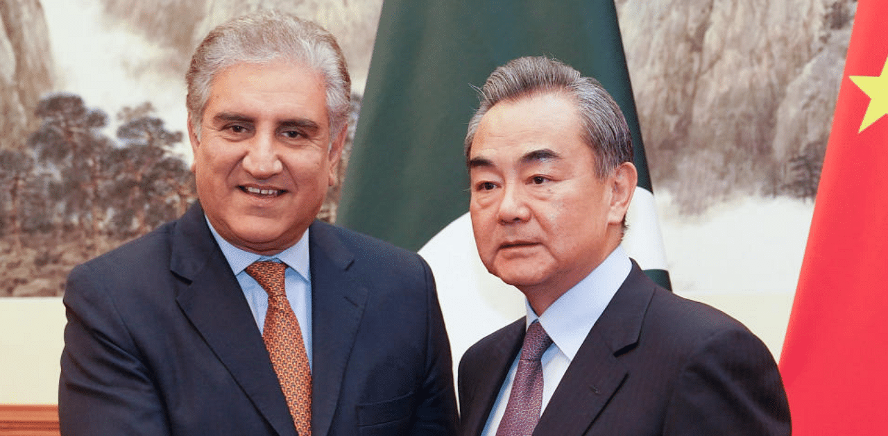 Chinese Foreign Minister Wang Yi shakes hands with Pakistani Foreign Minister Shah Mehmood Qureshi. Credit: Reuters File Photo