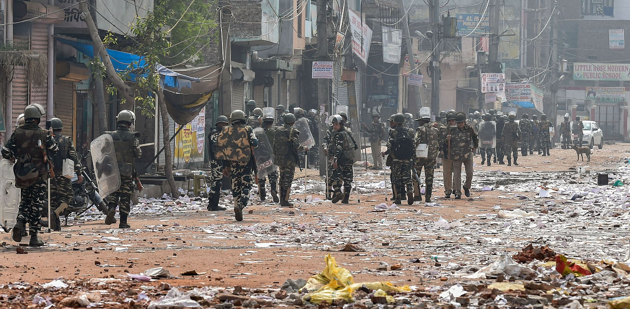 Security personnel conduct patrolling as they walk past Bhagirathi Vihar area of the riot-affected north east Delhi. Credit: PTI File Photo