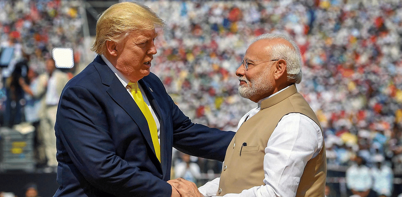 Prime Minister Narendra Modi shakes hands with US President Donald Trump during the 'Namaste Trump' event at Sardar Patel Stadium in Ahmedabad. Credit: PTI Photo