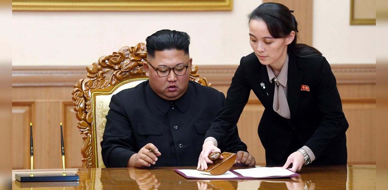 Kim Yo Jong, right, helps her brother North Korean leader Kim Jong Un sign a joint statement following the summit with South Korean President Moon Jae-in. Credits: AP