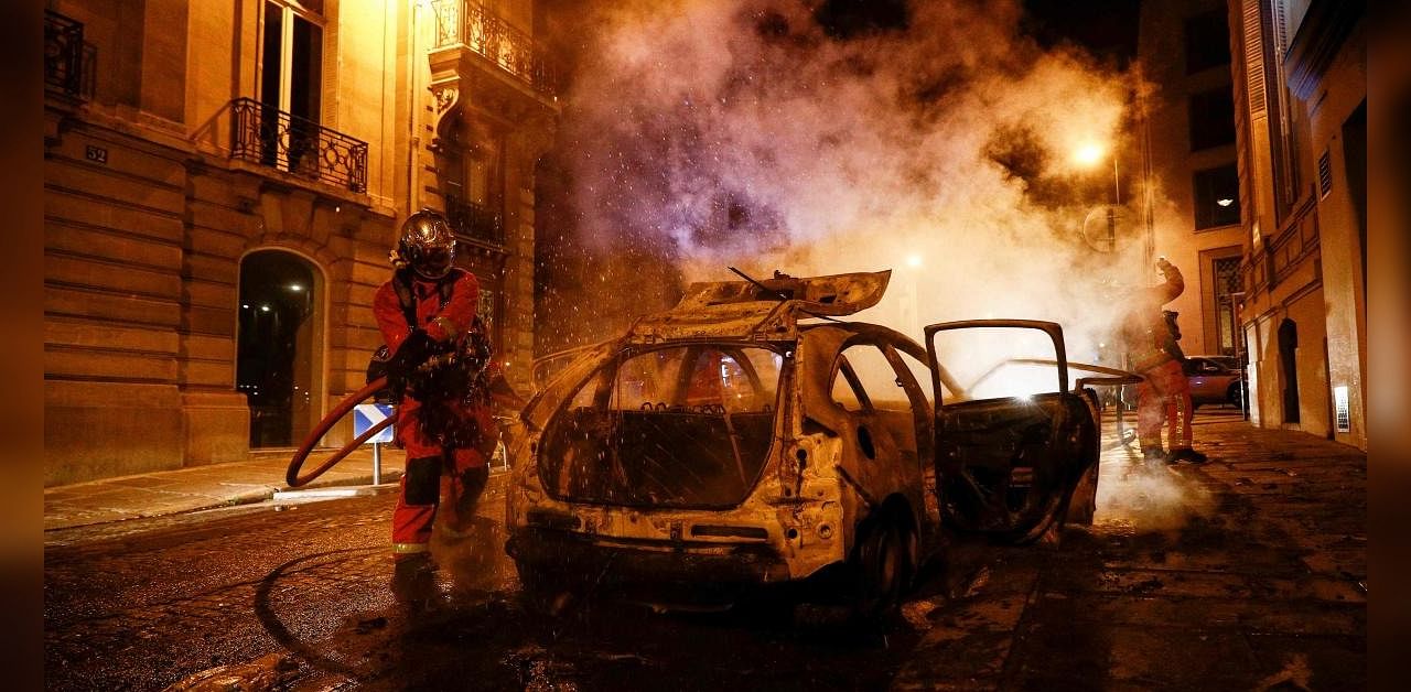 PSG fans fans set cars ablaze, smashed shop windows and clashed with police in the French capital after the team's defeat. Credits: AFP