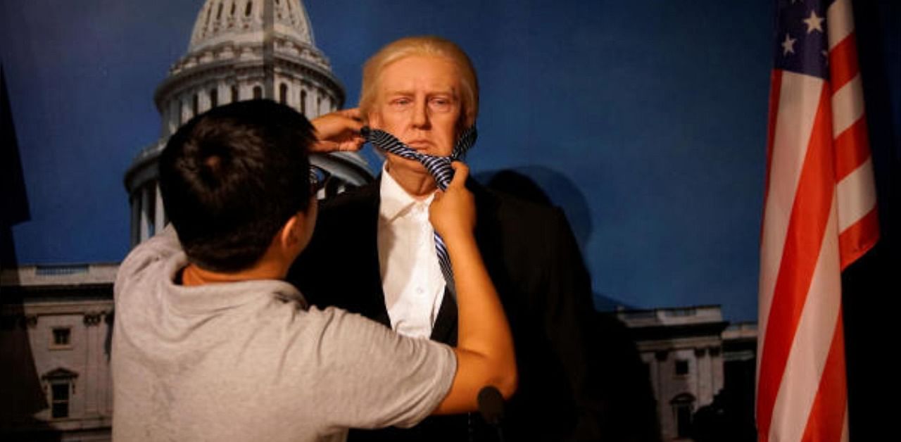 A technician demonstrates for the camera the assembling of a wax figure of US President Donald Trump at a wax museum of Shanghai Maiyi Arts. Credit: Reuters