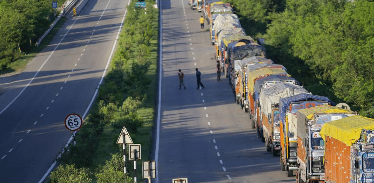 Trucks wait for the opening of Jammu-Srinagar national highway, on the outskirts of Jammu, Sunday, Aug 23, 2020. Credit: PTI Photo