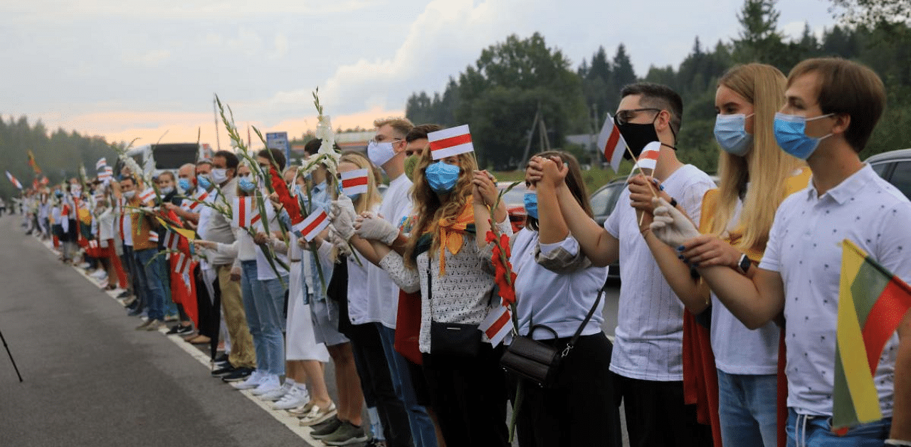 People form a human chain from Vilnius to Medininkai along the border with Belarus to show solidarity with the Belarussian people in Medininkai, Lithuania. Credit: AFP Photo