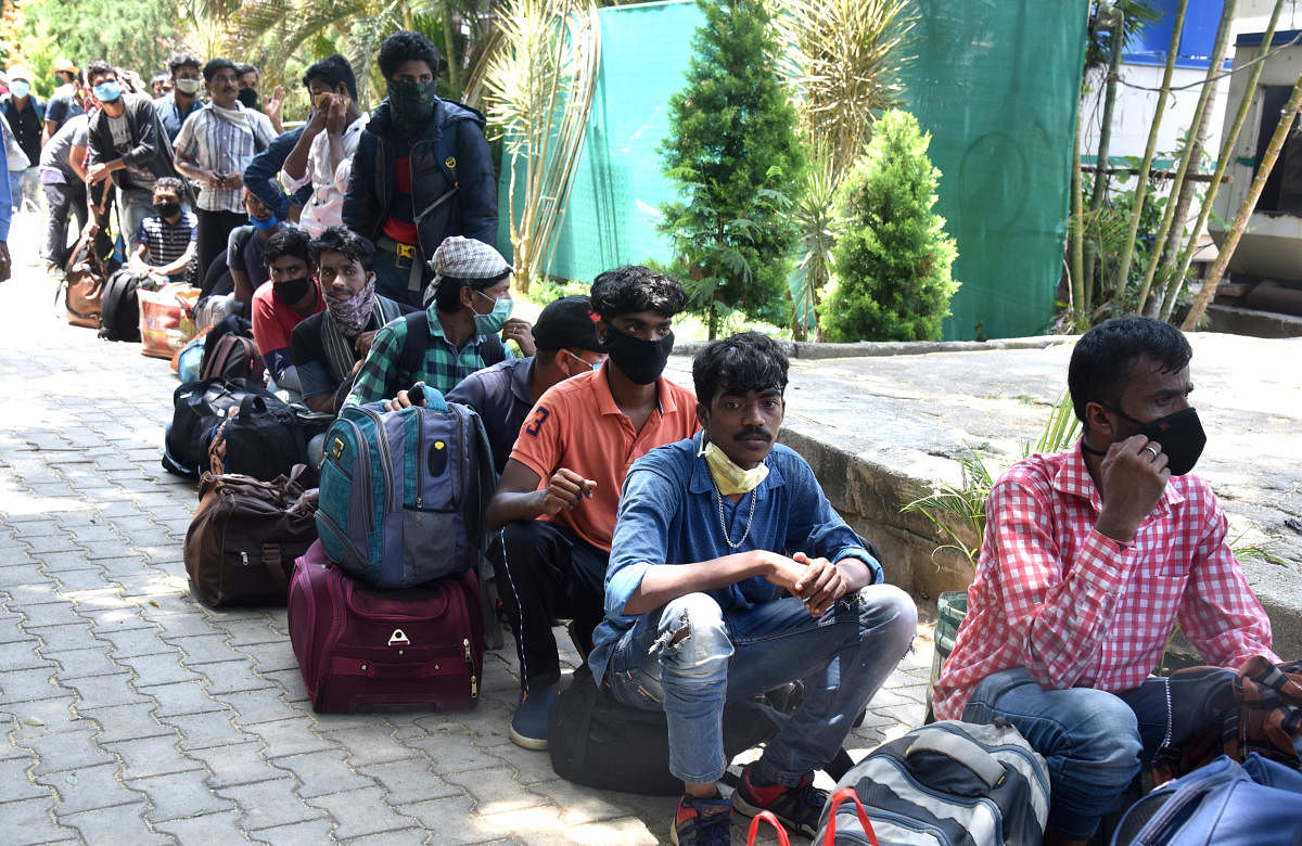 Migrant workers in queue to reach Odisha by Shramic special train at Palace grounds in Bengaluru on Sunday, 24 May 2020. Credit: PTI Photo