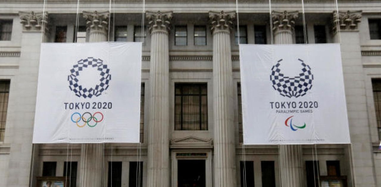 Logos of Tokyo 2020 Olympics and Paralympics are seen on the Mitsui Main Building in Tokyo. Credit: Reuters