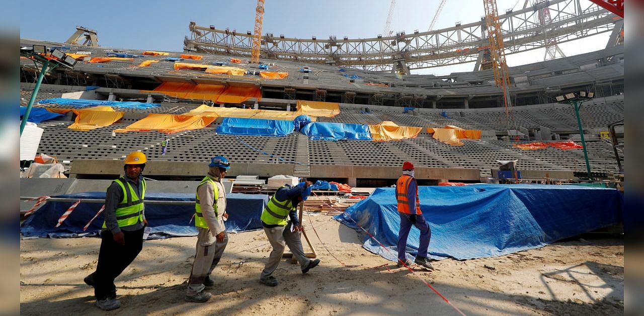 Workers are seen inside the Lusail stadium which is under construction for the upcoming 2022 FIFA soccer World Cup during a stadium tour in Doha, Qatar. Credits: Reuters