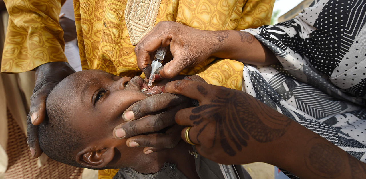  In this file photo taken on April 22, 2017 A Health worker administers a vaccine to a child during a vaccination campaign against polio at Hotoro-Kudu, Nassarawa district of Kano in northwest Nigeria. Credit: AFP Photo