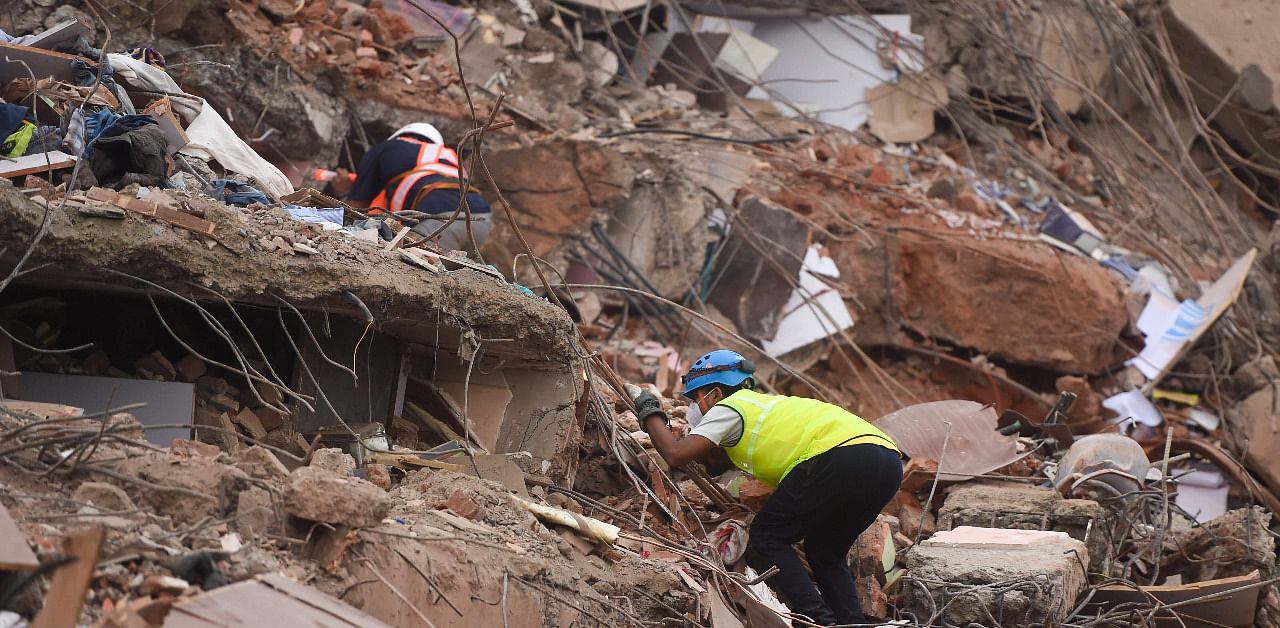Rescue workers search for people in the rubble of a five-storey apartment building after it collapsed in Mahad. Credit: AFP