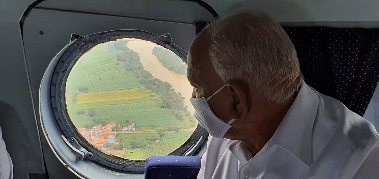 Chief Minister B S Yediyurappa conducting aerial inspection of rains and flood like situation losses in Belagavi and Bagalkot districts on Tuesday.