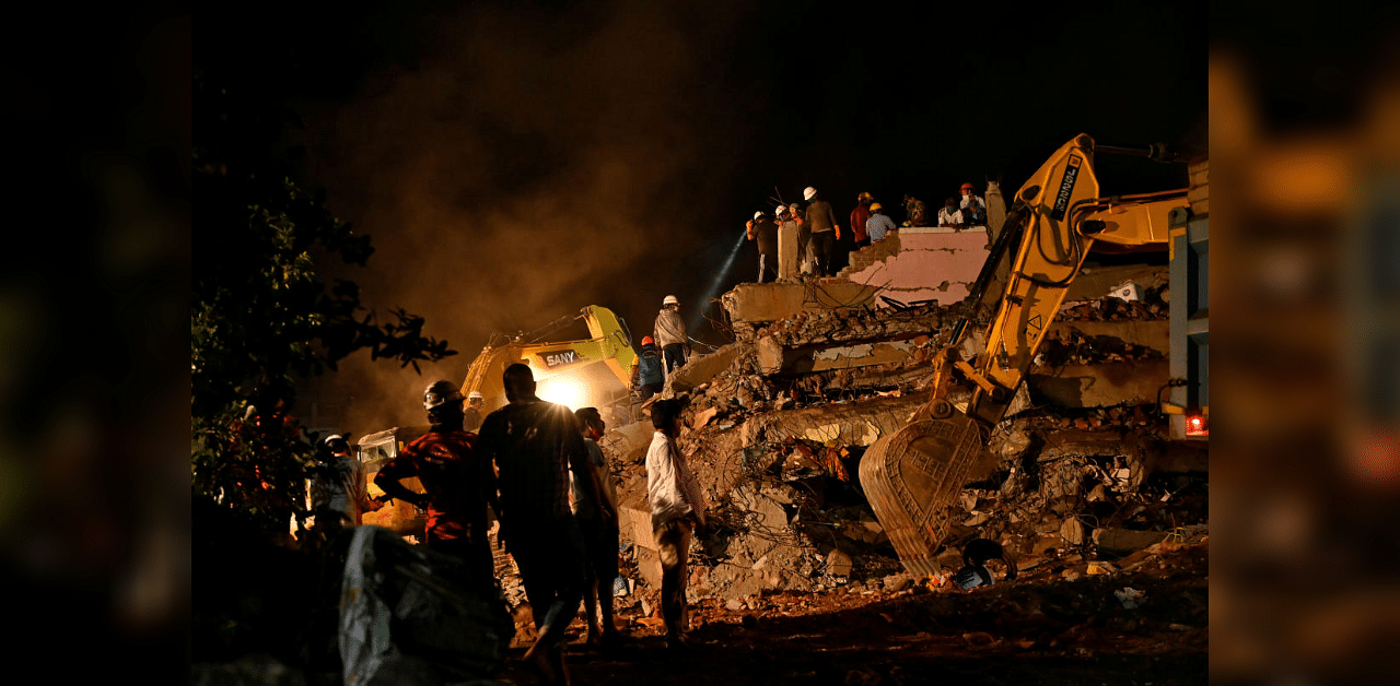 Rescue workers remove the debris as they search for survivors after a five-storey building collapsed in Mahad. Credit: Reuters